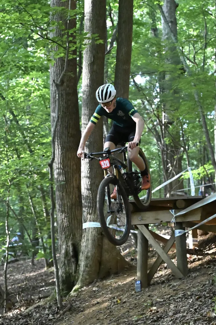 Rider airborne off a wooden feature